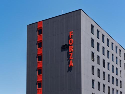 a building with a red sign on the side of it at Hotel Forza Nagasaki in Nagasaki