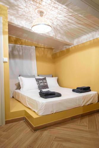 a bed in a room with a ceiling at KRISSAIA SEASIDE SUITES in Galaxidhion