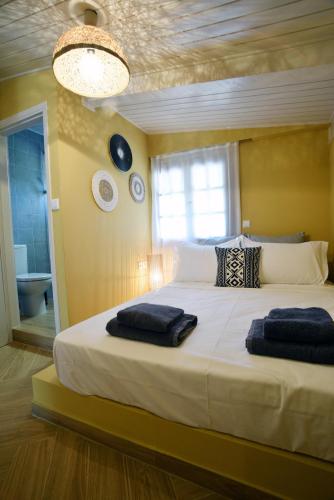 a bedroom with a large bed with two towels on it at KRISSAIA SEASIDE SUITES in Galaxidhion