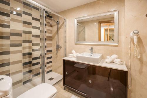 uma casa de banho com um lavatório e um chuveiro em Lanzahost LUX XXI em Arrecife