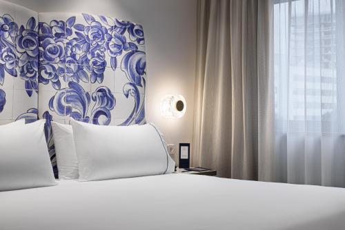 Кровать или кровати в номере Eurostars Universal Lisboa