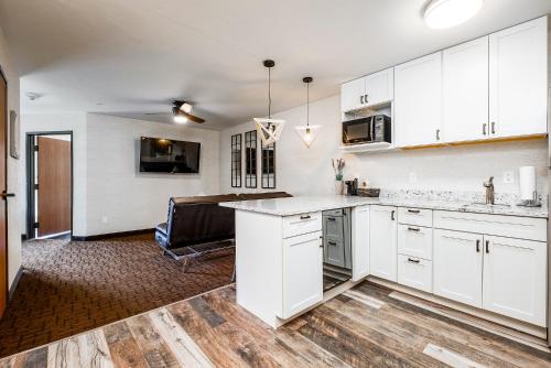 a kitchen with white cabinets and a counter top at Red Sands Hotel in Torrey