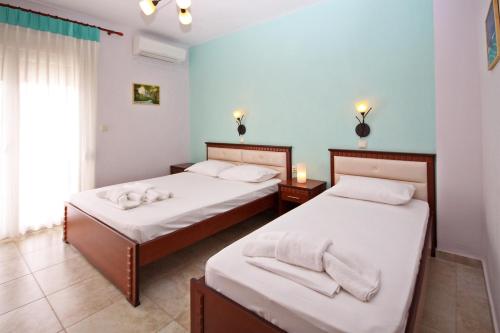 a bedroom with two beds with towels on them at Coralli Studios in Ormos Panagias