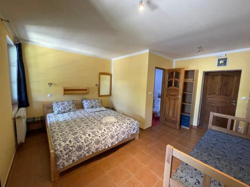 a bedroom with a bed and a room with a closet at Chata Ramzovské sedlo in Ramzová