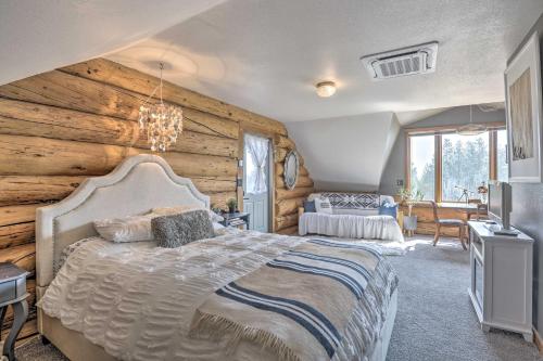a bedroom with a bed and a wooden wall at Fraser Couples Hideaway with Indian Peaks View in Fraser