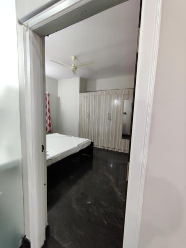 an empty room with a bed and a ceiling at Royal Wings Apartments in Mysore