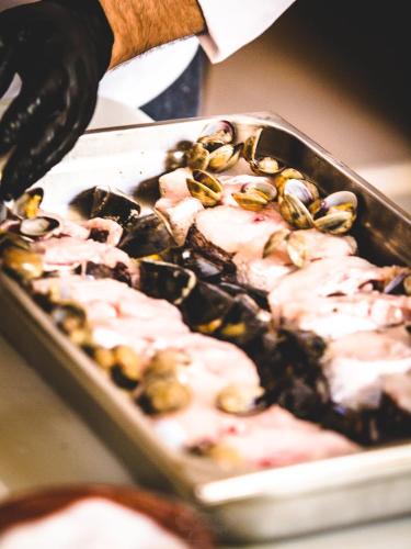 a tray of food with clams on top of it at La Sabina in Castillejo de Robledo
