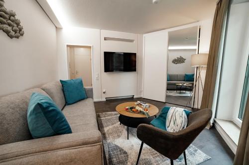 a living room with a couch and a table at Seehotel am Tankumsee in Isenbüttel