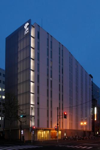 a large building with a sign on the side of it at JR Inn Sapporo in Sapporo