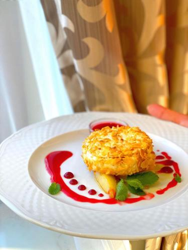 a white plate of food on a table at New Continent in Bushtyno