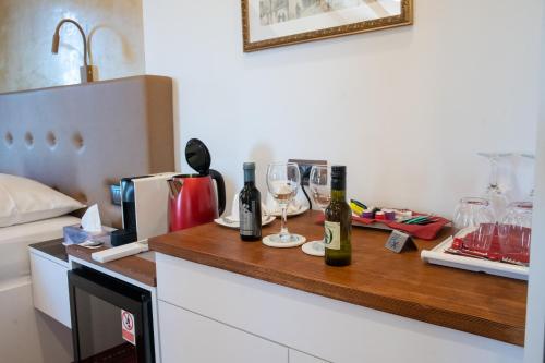 a kitchen counter with wine bottles and glasses on it at Oblivion Luxury Rooms in Split