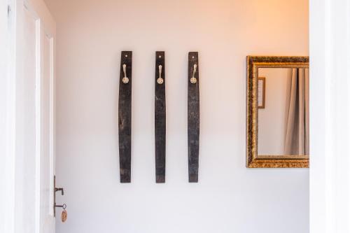 a group of skis on a wall next to a mirror at Villa Theresienhof in Rosegg