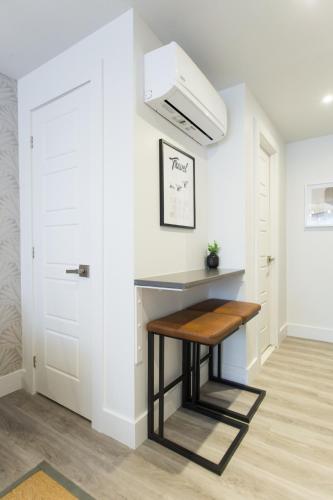 a small kitchen with a bench in a room at Serene and Styled Little Italy Studio full bath by Den Stays in Montréal