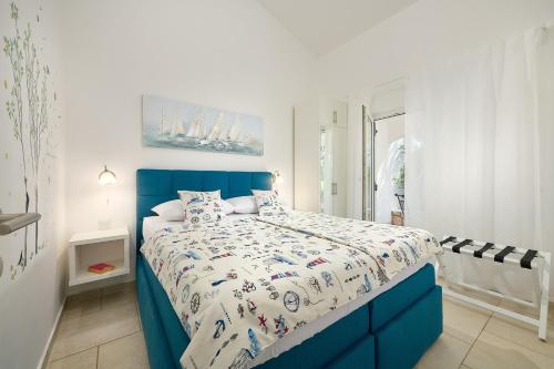 a bedroom with a blue and white bed in it at Holiday Park Mandrice in Mandre