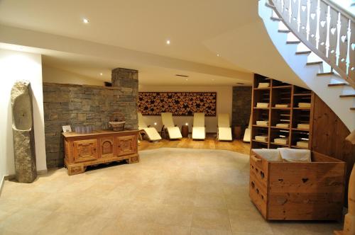 a wine cellar with a stone wall and a staircase at Hotel Arnaria in Ortisei