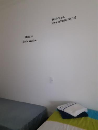 a bedroom with a bed with the words helloidaida music at Pousada Acolhedora in Ribeirão Preto