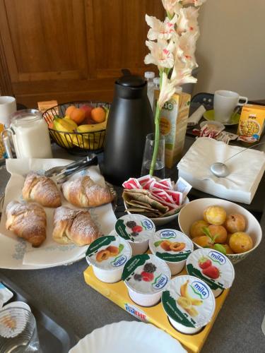 a table with plates of food and bowls of food at B&B L'Airone in Nogara