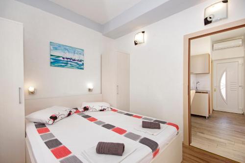 a bedroom with a large bed with a mirror at Apartmani ANDRIJA in Živogošće