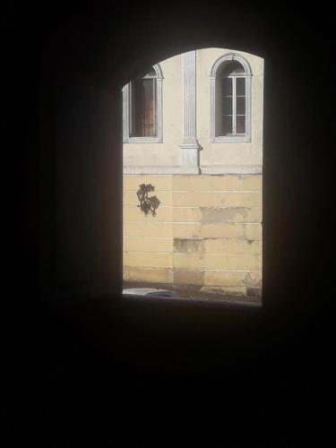 a view of a building through a window at Pousada Tiradentes in Ouro Preto