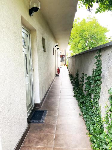 a hallway of a building with a door and plants at Hotel Guesthouse Stari Jasen in Zagreb