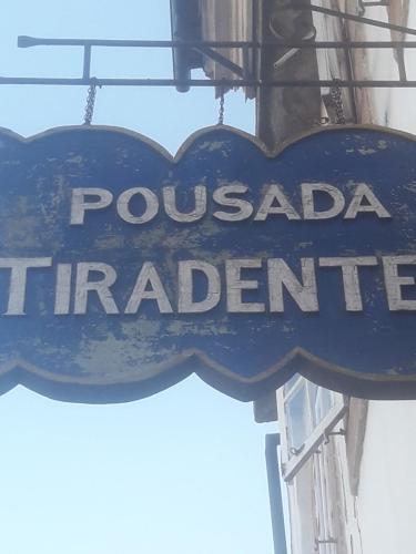 a sign for a pocomada triffeniciastery at Pousada Tiradentes in Ouro Preto