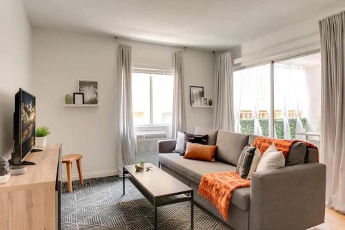a living room with a couch and a tv at Sophisticated Long Beach Suite with Patio Dining and Parking NRP21-00185 in Long Beach