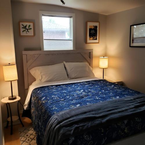 a bedroom with a bed with two lamps and a window at The Homestead in Chester