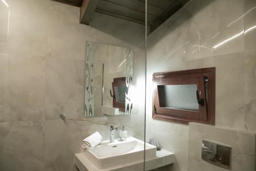 a bathroom with a sink and a mirror at Under the rocks meteora panoramic view villa in Kalabaka