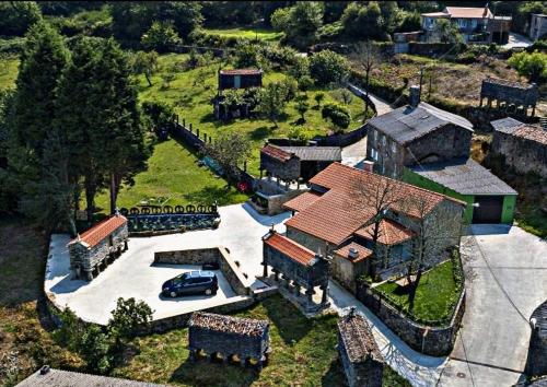 an aerial view of a house with a car in it at Casa da Loura - Costa da Morte in Dumbría