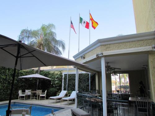 two flags on top of a building with a pool at Best Western Hotel Posada Del Rio Express in Torreón