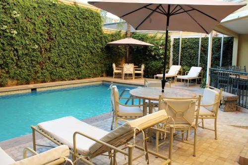 d'une terrasse avec une table et des chaises à côté de la piscine. dans l'établissement Best Western Hotel Posada Del Rio Express, à Torreón