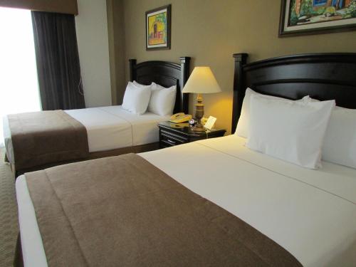 a hotel room with two beds and a telephone at Best Western Hotel Posada Del Rio Express in Torreón