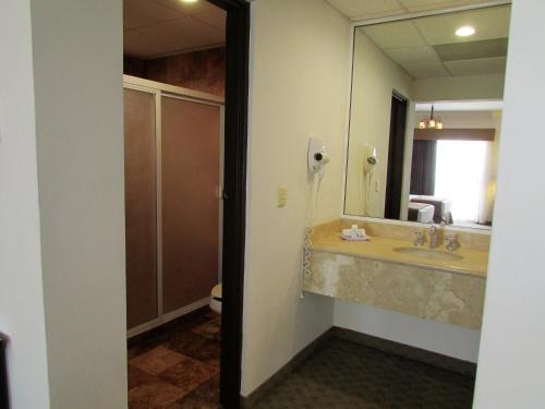 a bathroom with a sink and a mirror at Best Western Hotel Posada Del Rio Express in Torreón