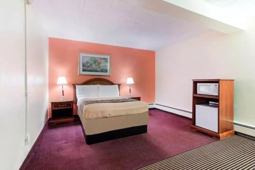 a hotel room with a bed and a tv at Royal Inn Clearfield in Clearfield