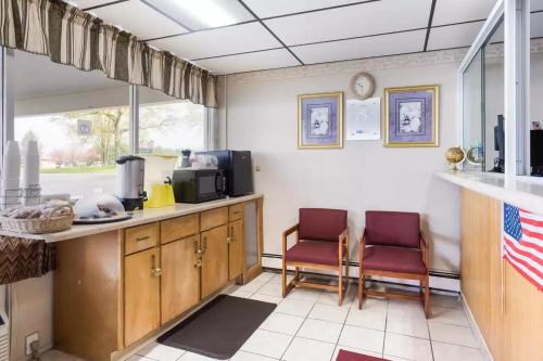 a kitchen with two chairs and a counter top at Royal Inn Clearfield in Clearfield
