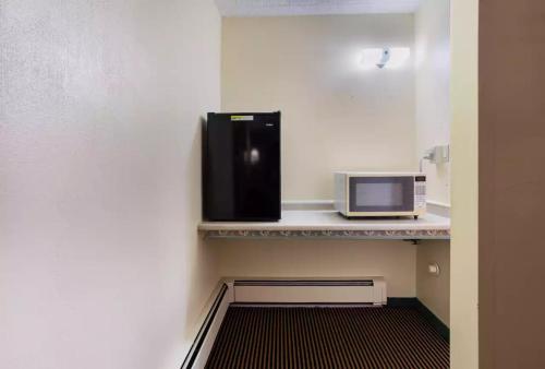 a microwave sitting on a counter in a room at Royal Inn Clearfield in Clearfield