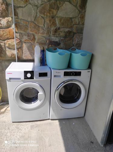 two washing machines with bowls on top of them at La casita del abuelo in Galizano