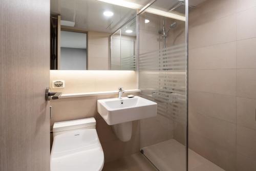 a bathroom with a toilet and a sink and a shower at Kumho Hwasun Spa Resort in Hwasun