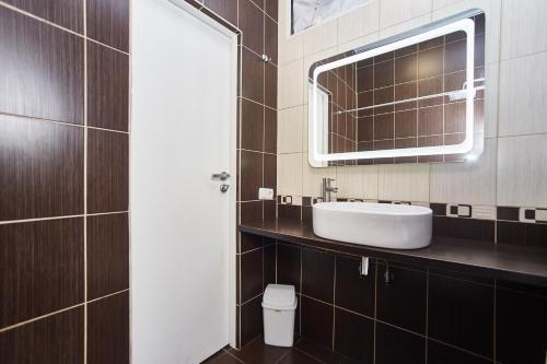 a bathroom with a sink and a mirror at Old Courtyard Hostel in Odesa