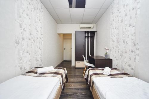a hospital room with two beds and a desk at Old Courtyard Hostel in Odesa