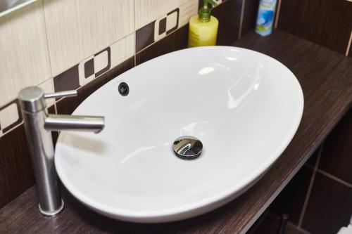 a white sink in a bathroom at Old Courtyard Hostel in Odesa