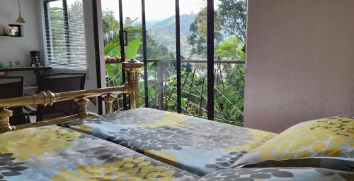 a bedroom with a bed and a large window at Aire Libre Descanso in San Francisco
