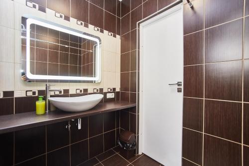 a bathroom with a sink and a mirror at Old Courtyard Hostel in Odesa