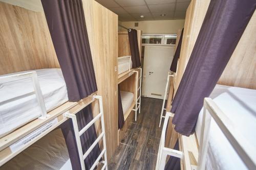a small room with two bunk beds in a caravan at Old Courtyard Hostel in Odesa