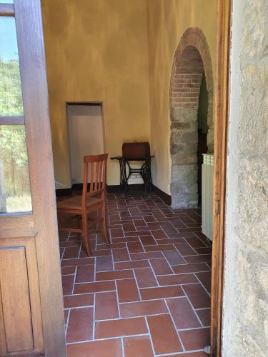 a hallway with a chair and a table in a room at - Agriturismo La Piaggia - forest view apartment on the ground floor 2 guests in Vivo dʼOrcia