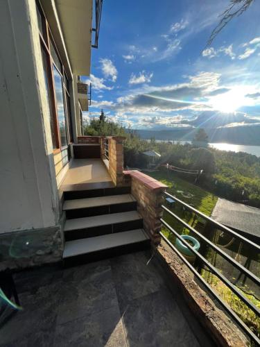 a balcony with stairs and a view of the water at APTO 102 EN "ABADIA de TOMINE" in Guatavita