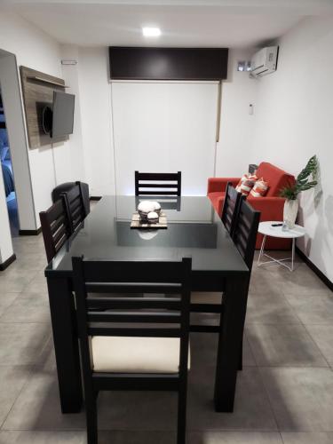 a table and chairs in a living room with a couch at Costanera.VM in Villa María