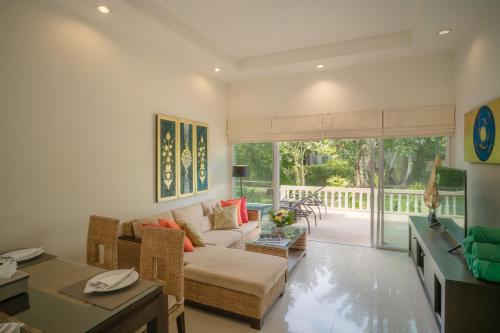 a living room with a couch and a table at Layantara Villas in Layan Beach