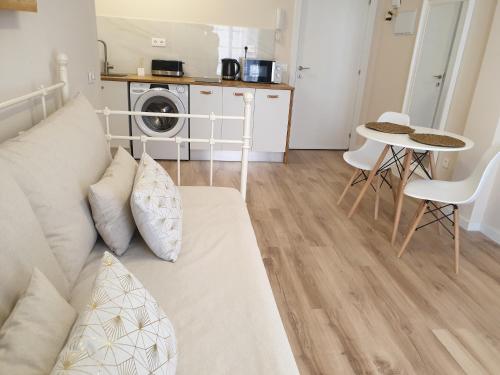 a living room with a couch and a table at Morrojable Luxury Beach Apartments in Morro del Jable