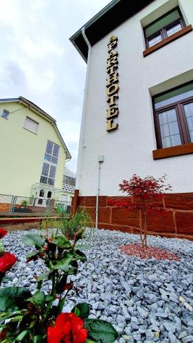 a building with a sign on the side of it at Zur Krone Aparthotel in Widdershausen